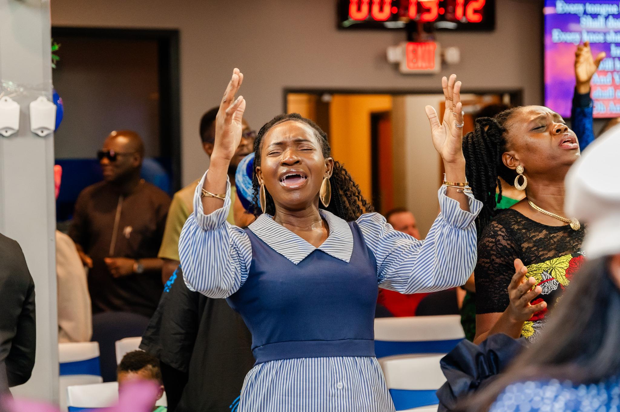 A worshipper with hands raised in praise